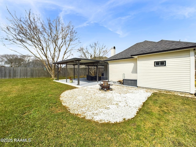 back of house featuring a fire pit, a lawn, and a patio area