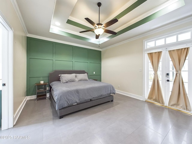 bedroom with ceiling fan, ornamental molding, a tray ceiling, and light tile patterned floors