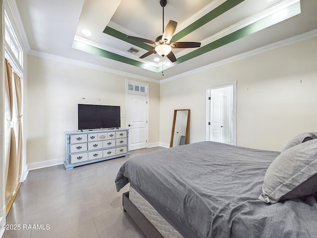 bedroom with crown molding, tile patterned floors, ceiling fan, and a tray ceiling