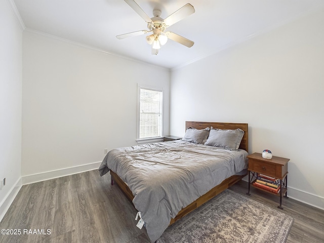 bedroom featuring ornamental molding, dark wood-type flooring, and ceiling fan