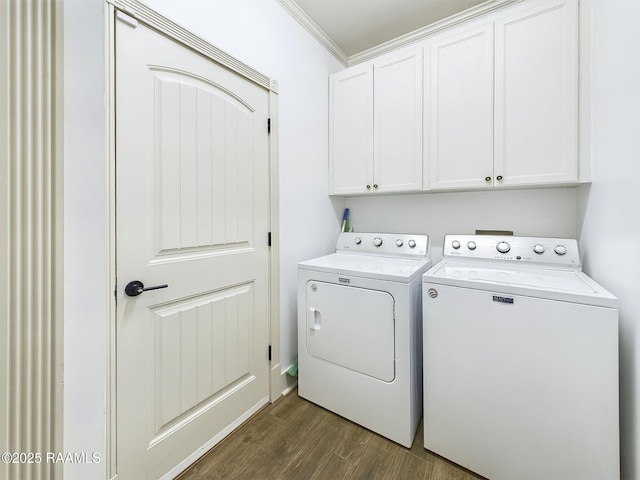 laundry room with cabinets, ornamental molding, dark hardwood / wood-style flooring, and separate washer and dryer