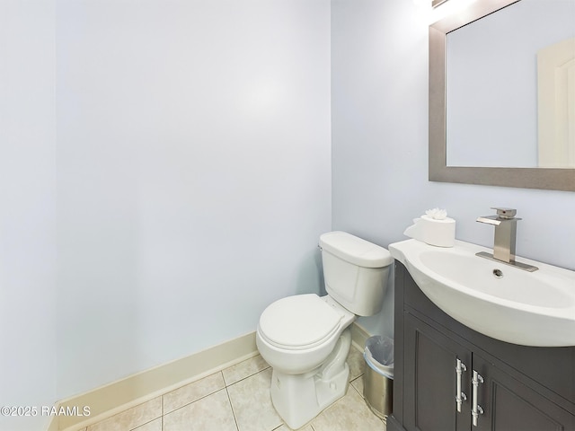 bathroom with vanity, tile patterned flooring, and toilet