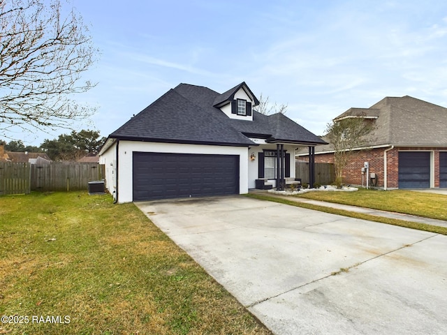 view of front facade featuring a garage, a front yard, and central air condition unit