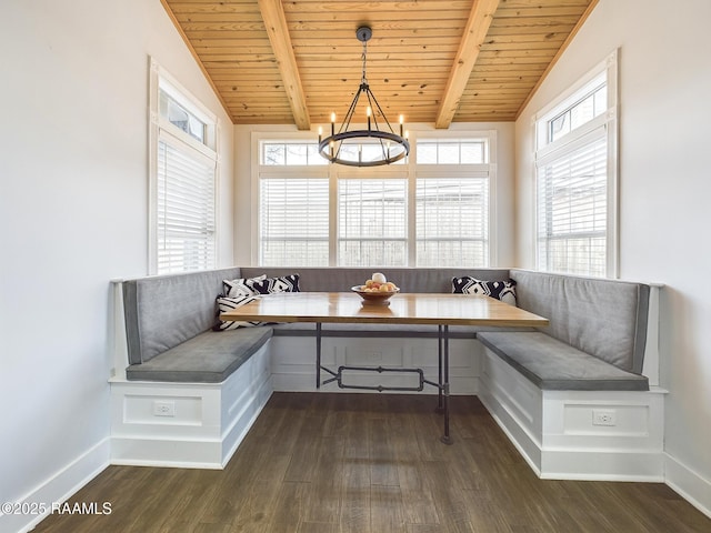 unfurnished room featuring breakfast area, dark hardwood / wood-style floors, and vaulted ceiling with beams