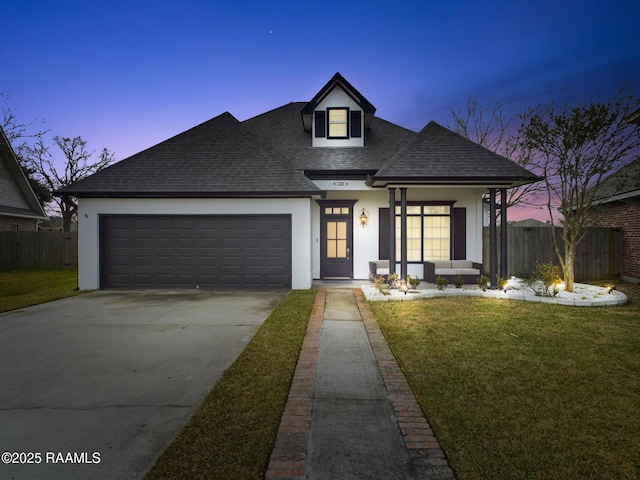 view of front of home featuring a garage and a yard