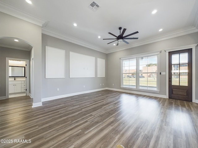 interior space with dark hardwood / wood-style flooring, ornamental molding, and ceiling fan