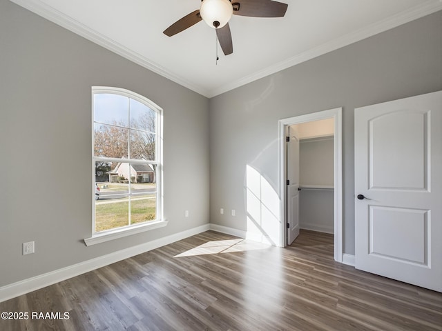 spare room with ornamental molding, dark hardwood / wood-style floors, and ceiling fan