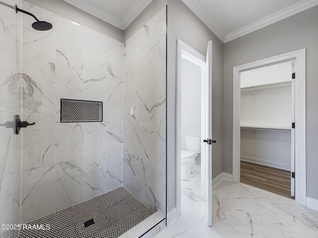 bathroom with tiled shower, ornamental molding, and toilet