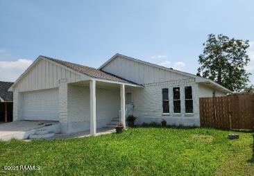 view of front of property with a front lawn and a garage