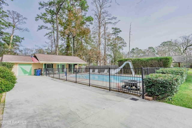 view of pool featuring a water slide and a patio area