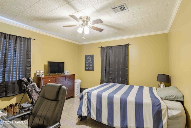 bedroom featuring ceiling fan and crown molding