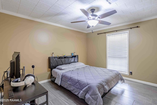 bedroom with ceiling fan, crown molding, and multiple windows