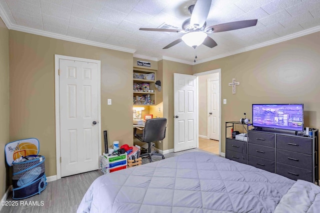 bedroom featuring ceiling fan, light wood-type flooring, and ornamental molding