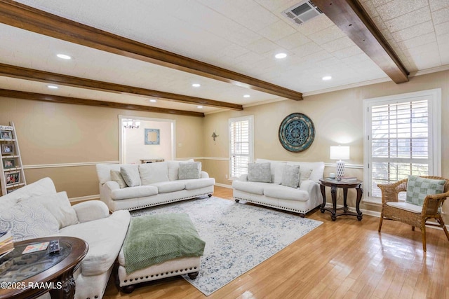 living room with light wood-type flooring and beamed ceiling