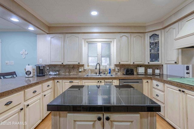 kitchen with stainless steel dishwasher, a center island, light wood-type flooring, backsplash, and sink