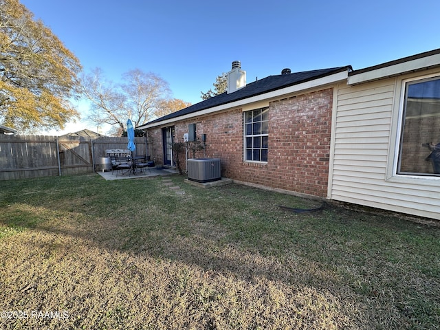 view of yard featuring central AC and a patio