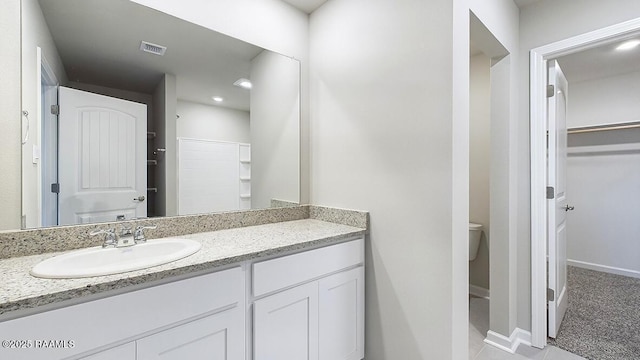 bathroom featuring vanity and toilet