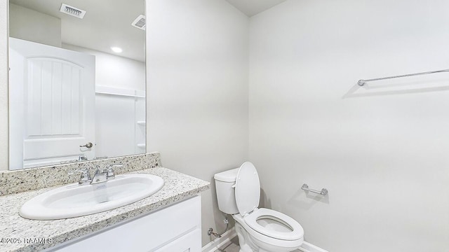 bathroom with toilet and vanity