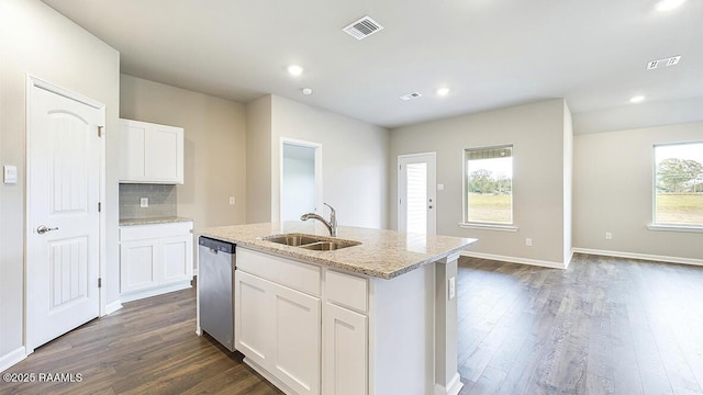 kitchen featuring dishwasher, an island with sink, decorative backsplash, white cabinets, and sink