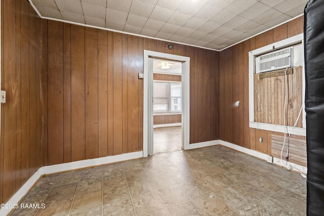 spare room with wood walls