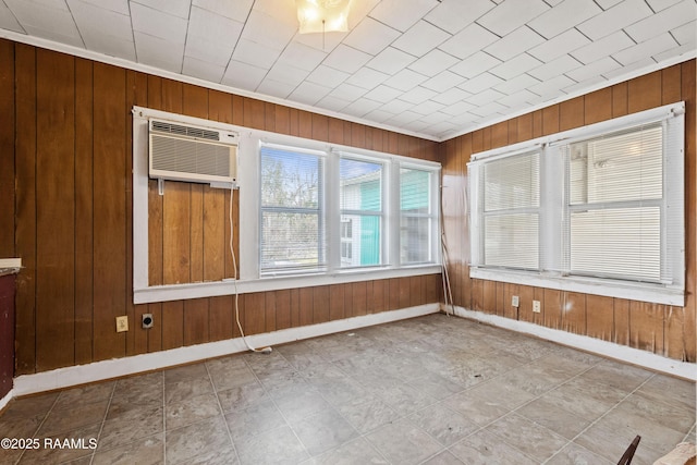 spare room with wooden walls and an AC wall unit