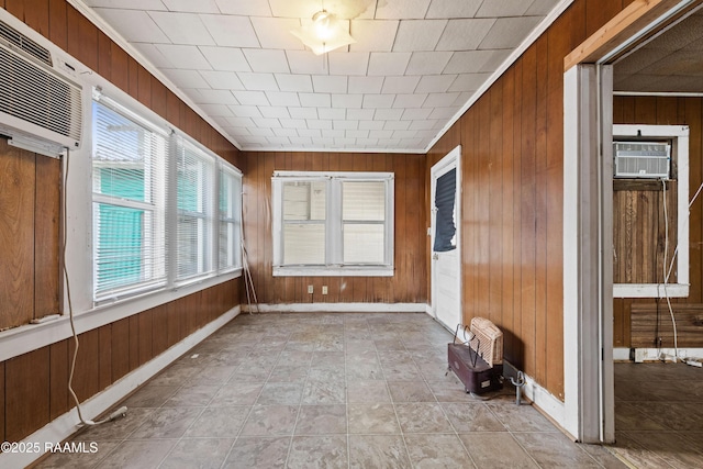 unfurnished sunroom with a wall mounted air conditioner