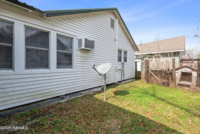 view of home's exterior with a yard and a wall mounted AC