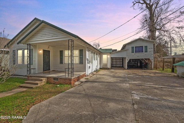 bungalow featuring a carport and a porch