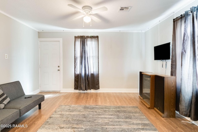 living room with light hardwood / wood-style floors and ceiling fan