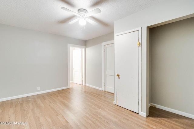 unfurnished bedroom featuring ceiling fan, light hardwood / wood-style floors, and a textured ceiling