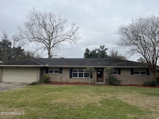 ranch-style home with a front yard and a garage