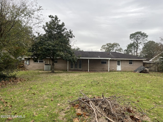 rear view of house with a lawn