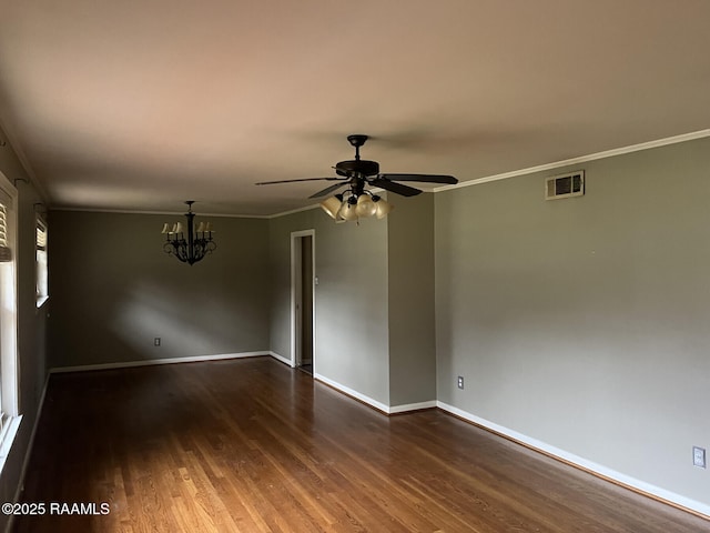 empty room featuring dark hardwood / wood-style floors, ceiling fan with notable chandelier, and ornamental molding