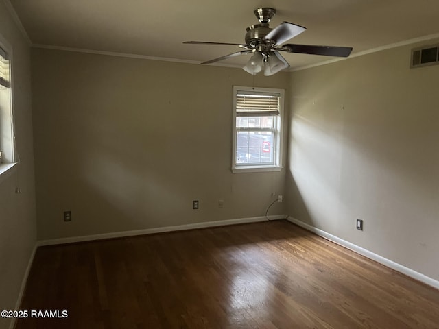 spare room featuring ceiling fan, ornamental molding, and dark hardwood / wood-style floors