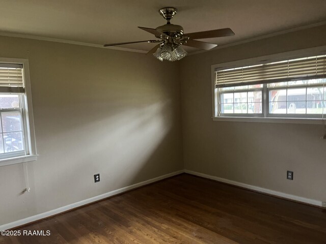 empty room with ceiling fan, dark hardwood / wood-style flooring, and crown molding