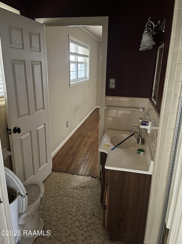 bathroom featuring toilet, vanity, crown molding, and hardwood / wood-style floors