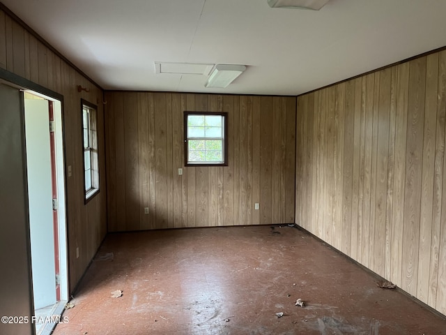 spare room featuring wooden walls