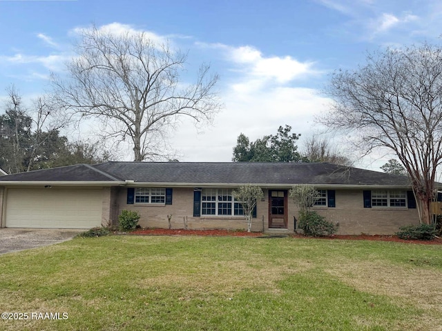 ranch-style house featuring a garage and a front lawn