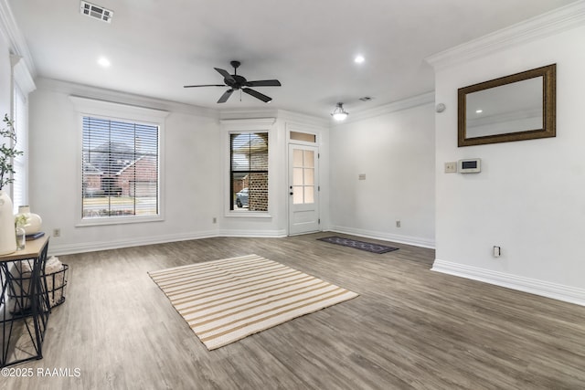 unfurnished living room featuring ceiling fan, ornamental molding, and hardwood / wood-style floors