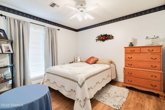 bedroom with wood-type flooring and ceiling fan