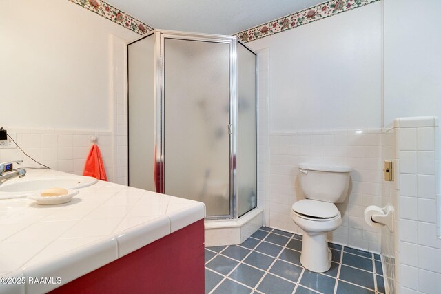 bathroom with toilet, an enclosed shower, vanity, and tile patterned floors