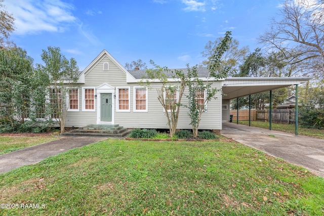 view of front of house with a front lawn and a carport