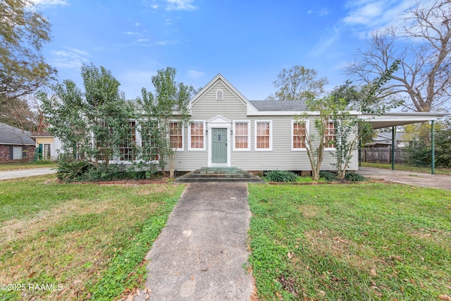 view of front of house with a front yard and a carport