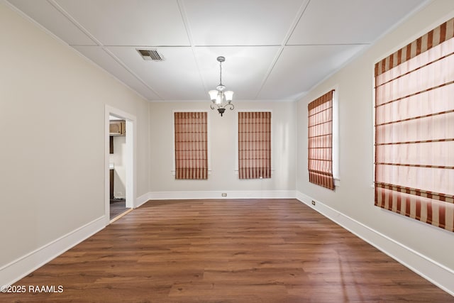 unfurnished dining area with dark hardwood / wood-style flooring and a notable chandelier