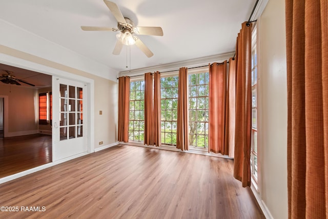 spare room with ceiling fan and hardwood / wood-style flooring