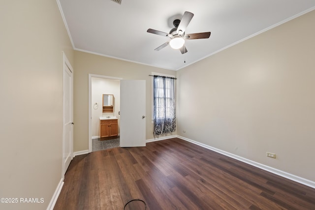 unfurnished bedroom with ceiling fan, dark wood-type flooring, ensuite bathroom, and crown molding