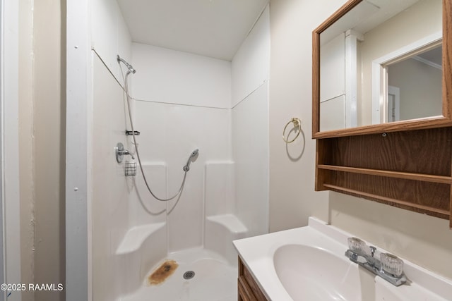 bathroom featuring walk in shower and vanity