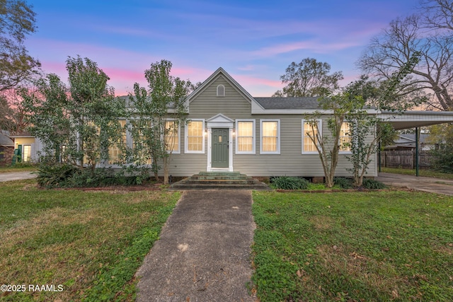 bungalow with a yard and a carport