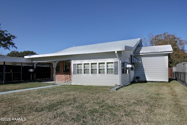 rear view of property featuring a yard