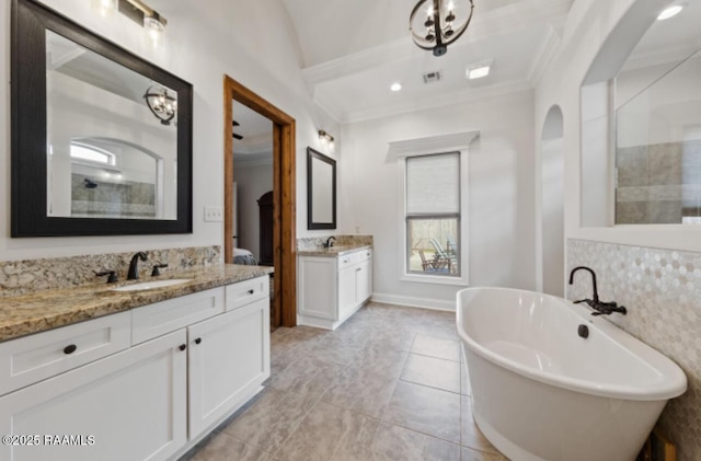 bathroom featuring crown molding, vanity, and a bathing tub